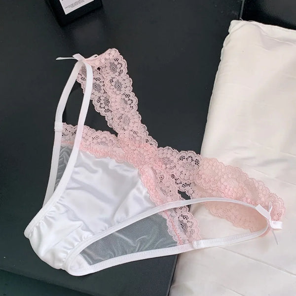 Flat lay of white satin briefs with wide pink lace panels and ribbon details