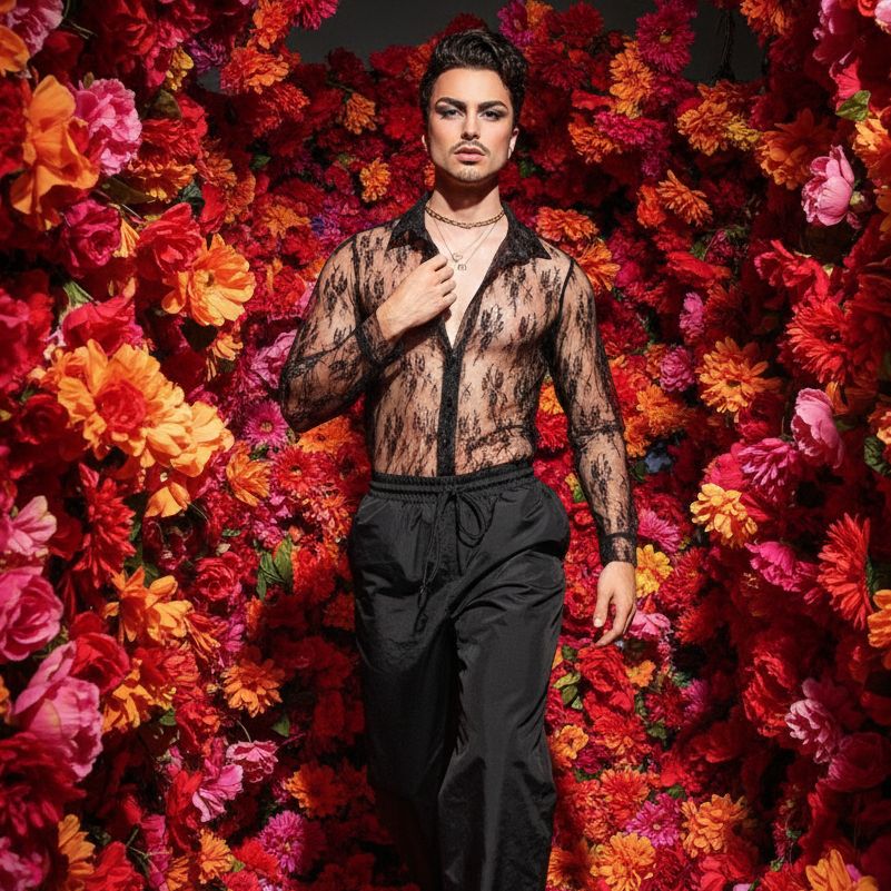 Front-view model wearing a sheer black lace shirt among vivid red and orange flowers