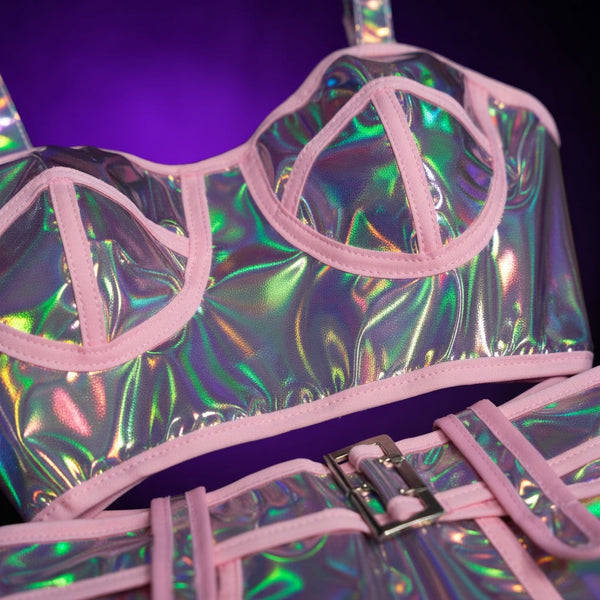 Close-up of an iridescent holographic costume with pink trim and a buckle