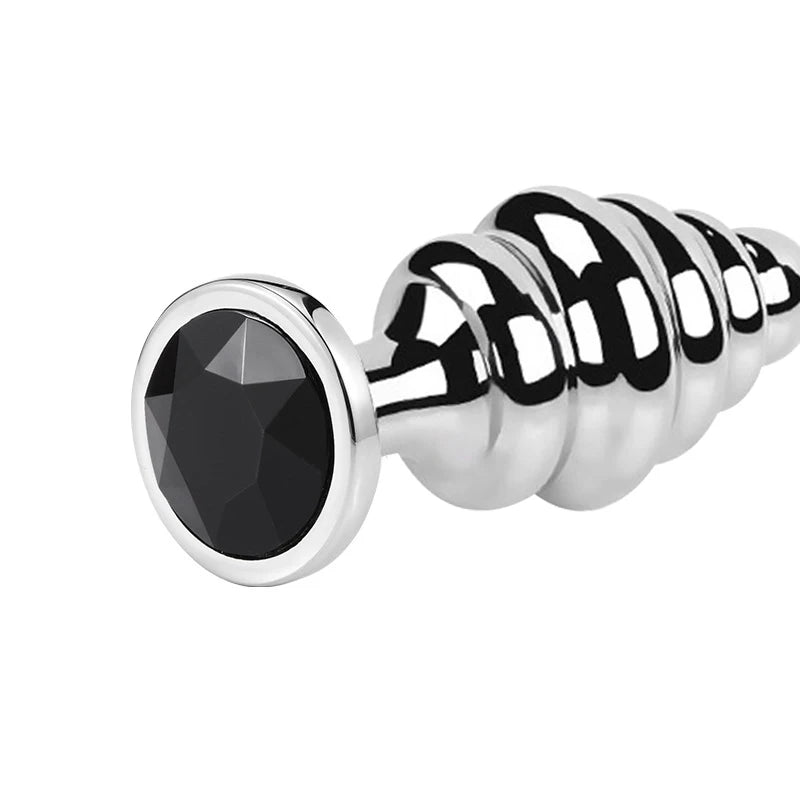 Polished stainless steel ribbed butt plug with a large black faceted jewel and flared base