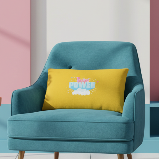 Teal armchair with Stand Proud Trans Power Pillow, showing “Trans Power” in blue and white on a white cloud, pink, blue