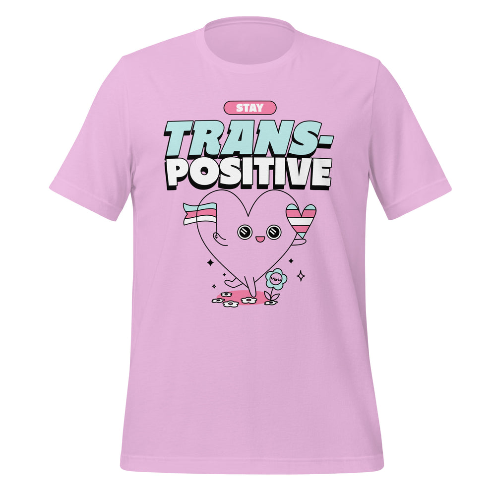 Pink Stay Trans-Positive T-shirt with “STAY TRANS-POSITIVE” over a smiling heart in trans flag stripes and bright sparkles.