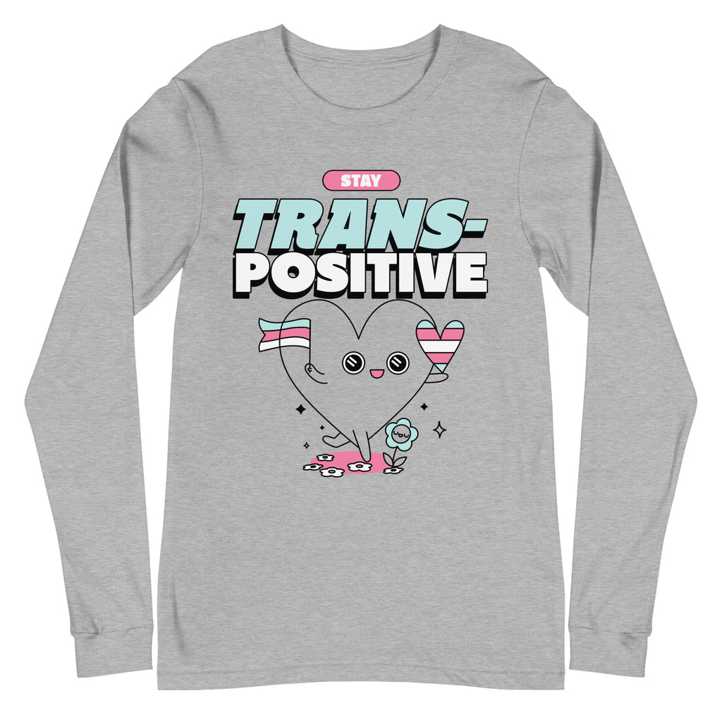 Front view of a gray long-sleeve shirt reading “STAY TRANS-POSITIVE,” with a heart character
