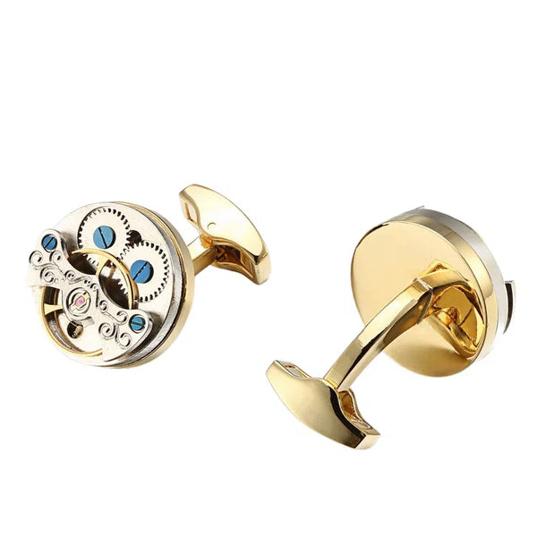 Pair of gold-tone steampunk cufflinks, one showing exposed gears and blue screws