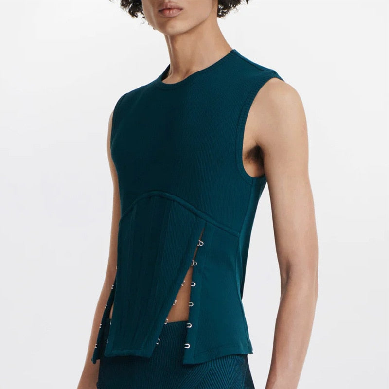 Model in a teal sleeveless ribbed top with a corset-style front and hook closures