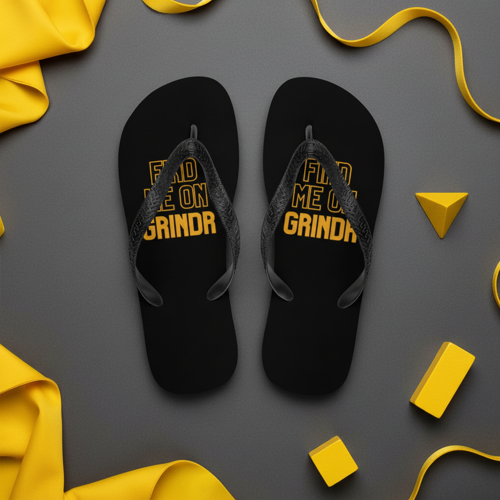 Black flip-flops with bold yellow "FIND ME ON GRINDR" text, laid side by side on gray, accented by yellow ribbon and blocks.