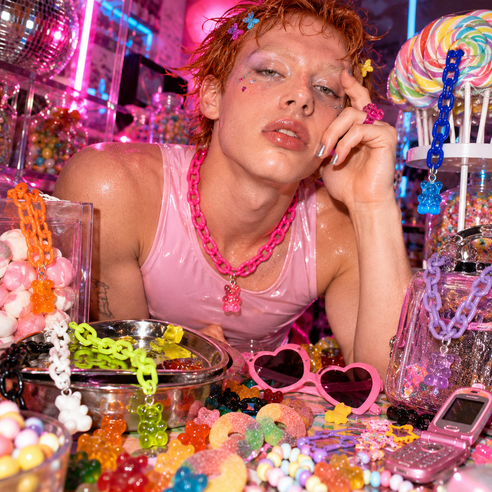 Close-up model wearing a bright pink gummy-bear chain necklace with a matching pendant