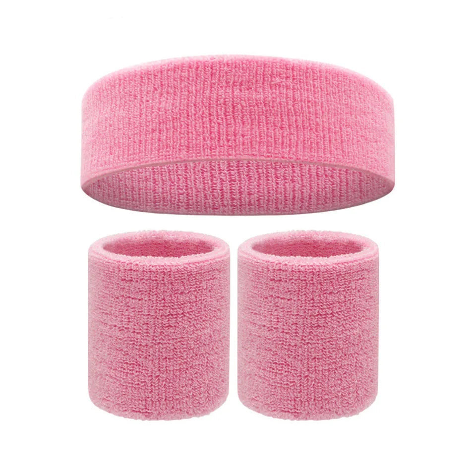 Three-piece pink terry cloth fitness set with one wide headband and two wristbands
