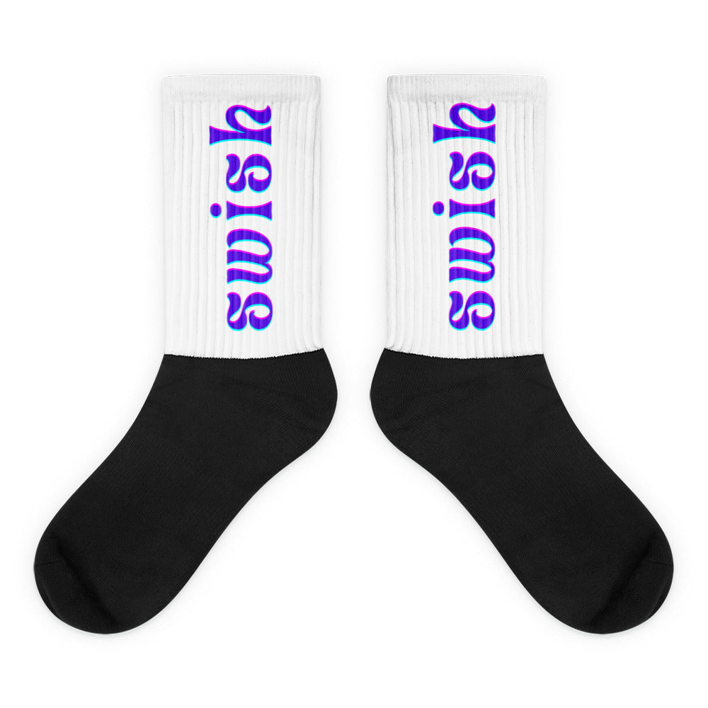 Pair of black-and-white crew socks with colorful vertical “swish” lettering