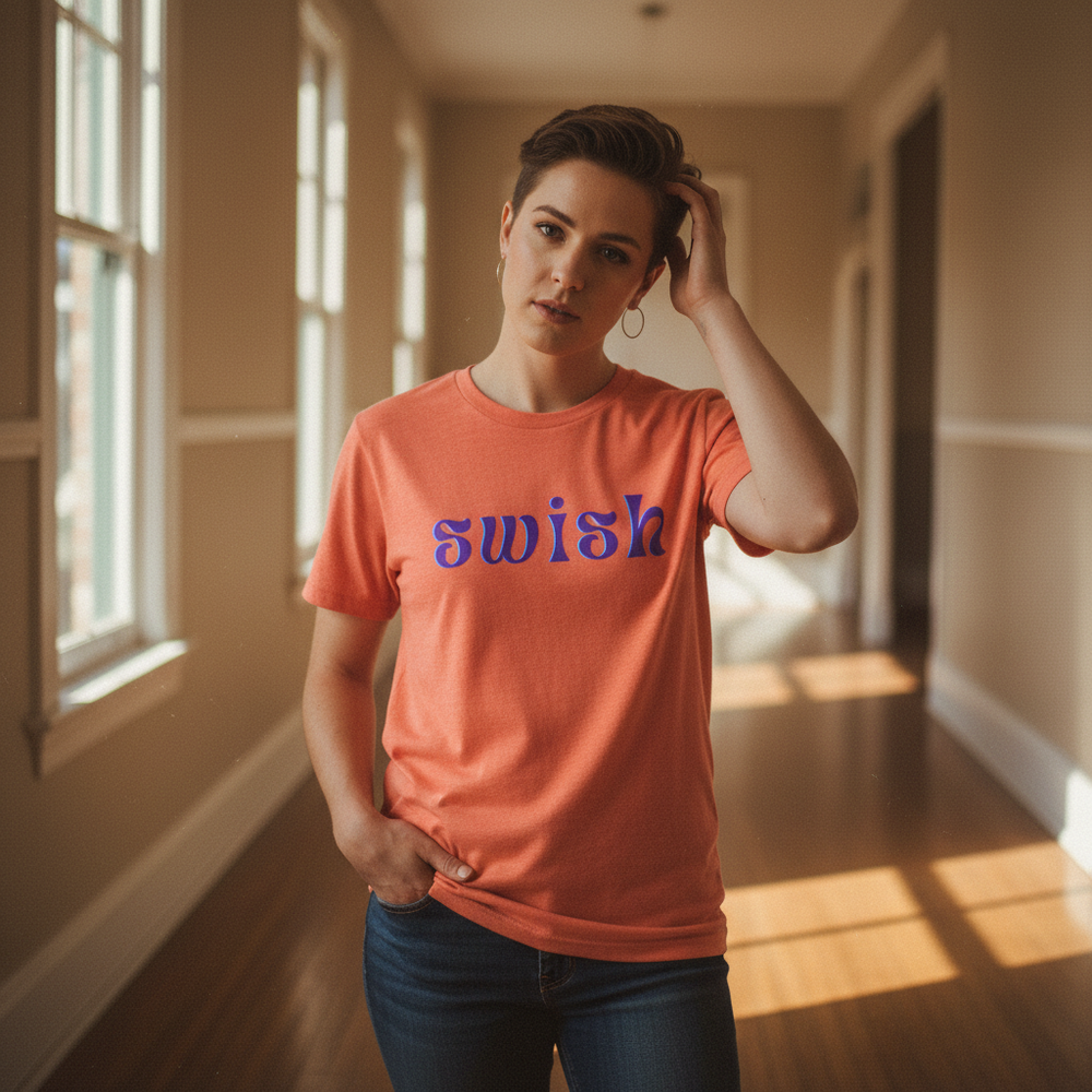 Coral Swish T-Shirt with bold purple lettering, styled with blue jeans