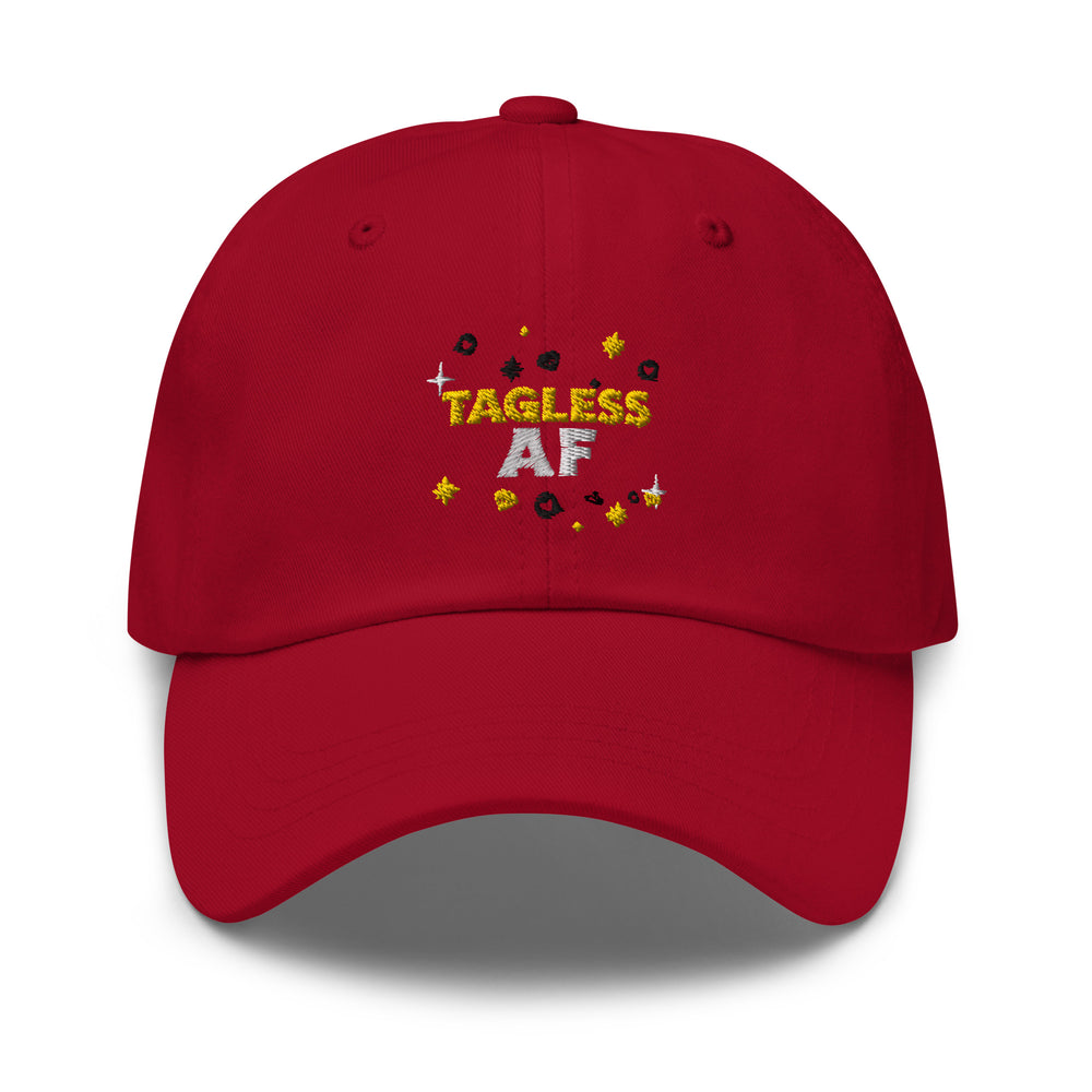 Front view of a red cap embroidered with “TAGLESS AF” and scattered stars and dots