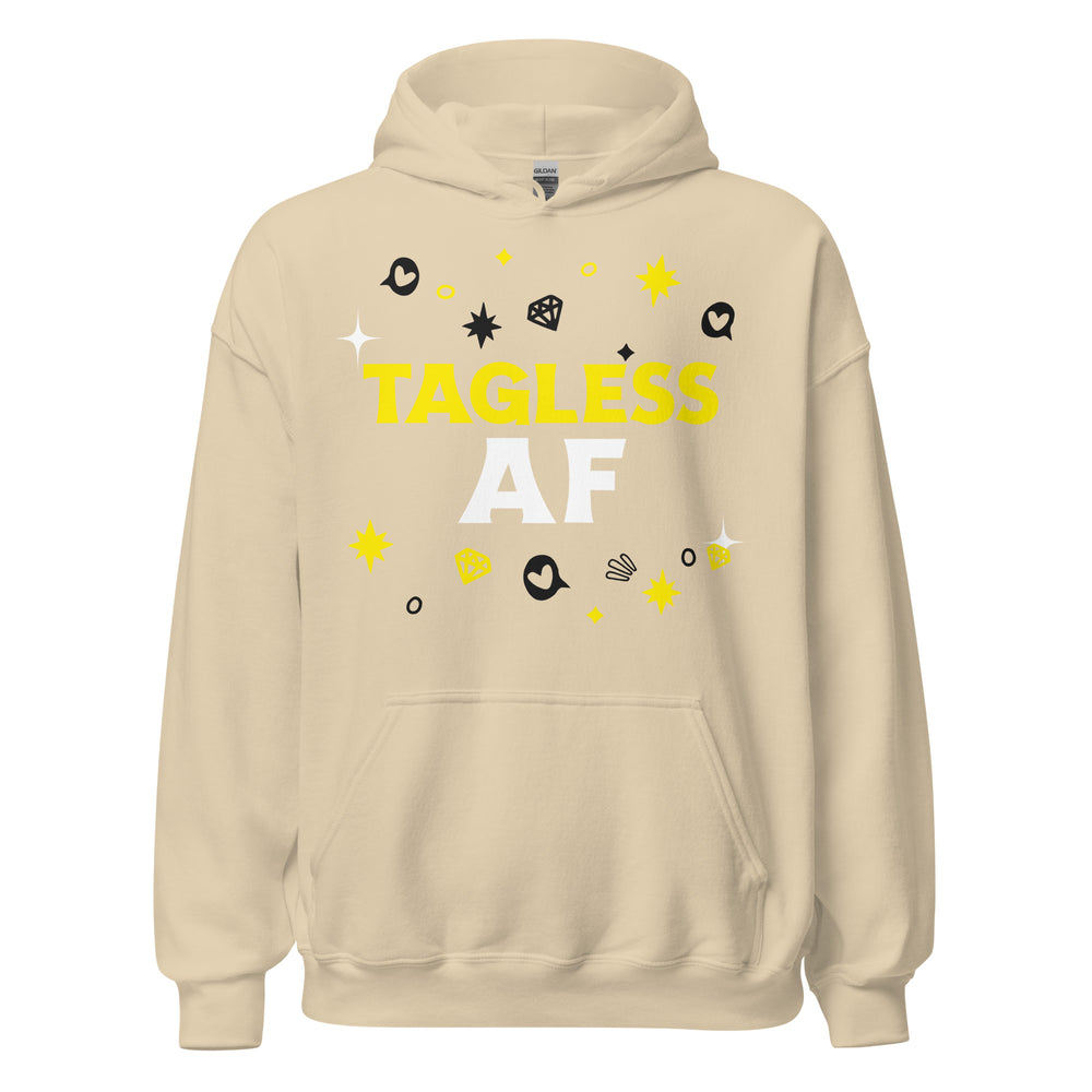 Beige gender-neutral hoodie, "TAGLESS AF" in bold white and yellow, cartoon stars, hearts, diamonds; front pocket