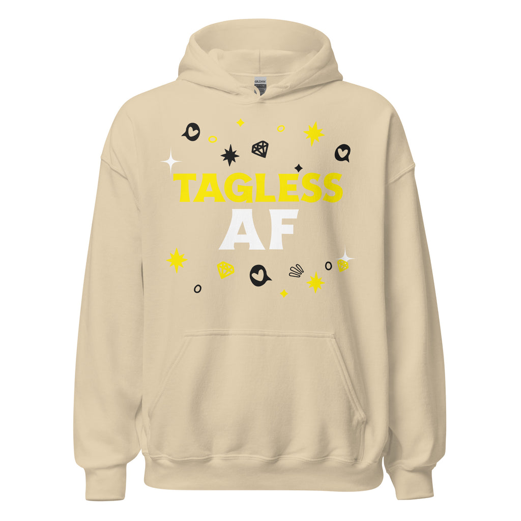 Beige gender-neutral hoodie, "TAGLESS AF" in bold white and yellow, cartoon stars, hearts, diamonds; front pocket