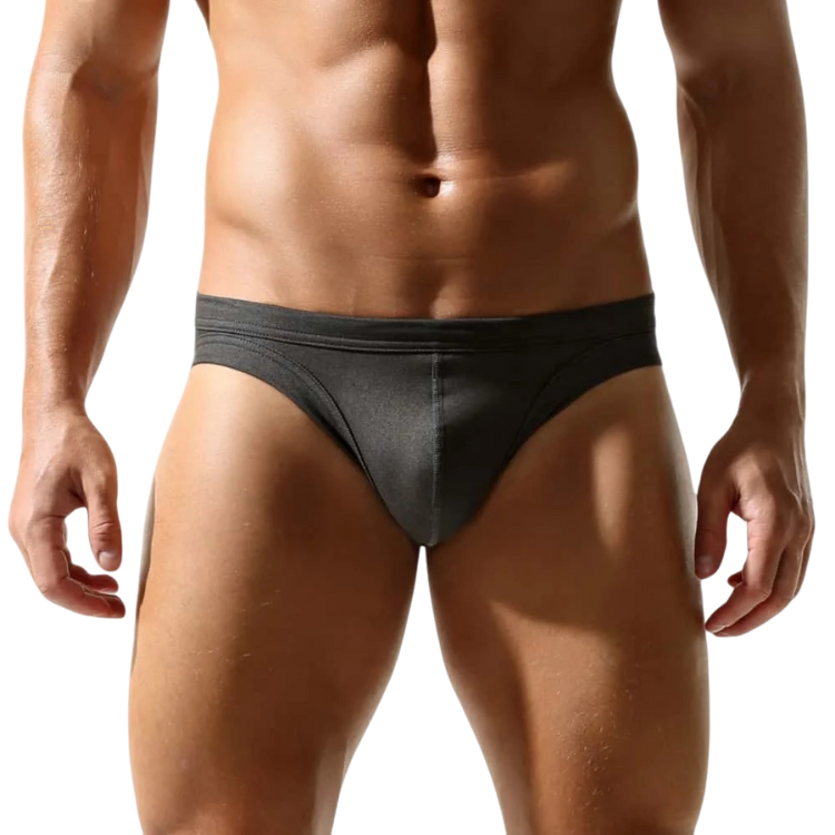 Front view of a model wearing black low-rise briefs against a white background