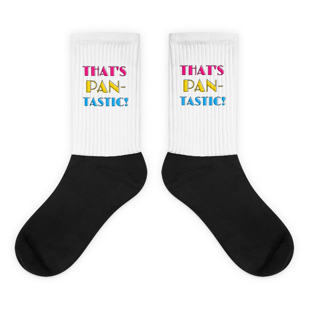 Pair of black-and-white socks reading “THAT’S PAN-TASTIC!” in pink, yellow, and blue