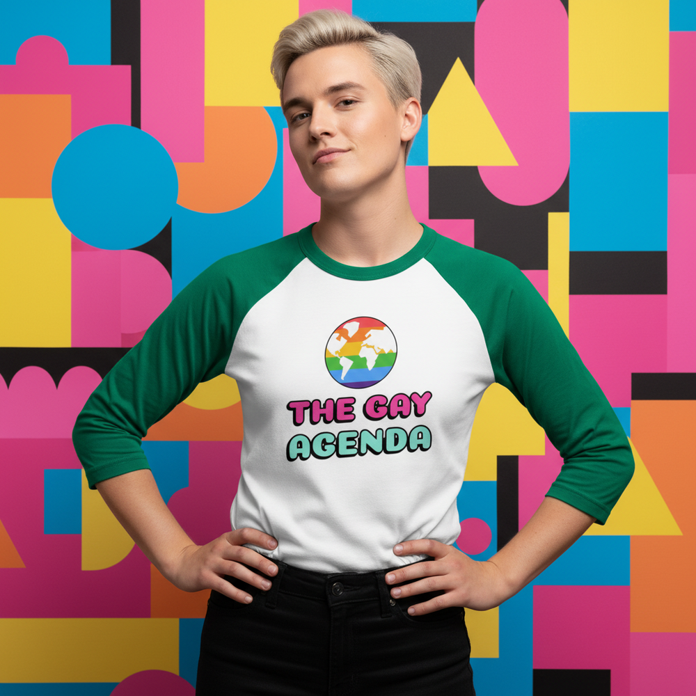 Model wearing a green-and-white raglan shirt reading “THE GAY AGENDA” with a rainbow globe