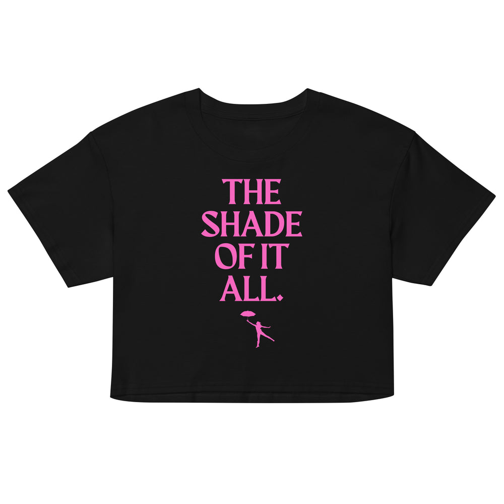 Front view of a black crop top with pink “THE SHADE OF IT ALL.” text and umbrella figure