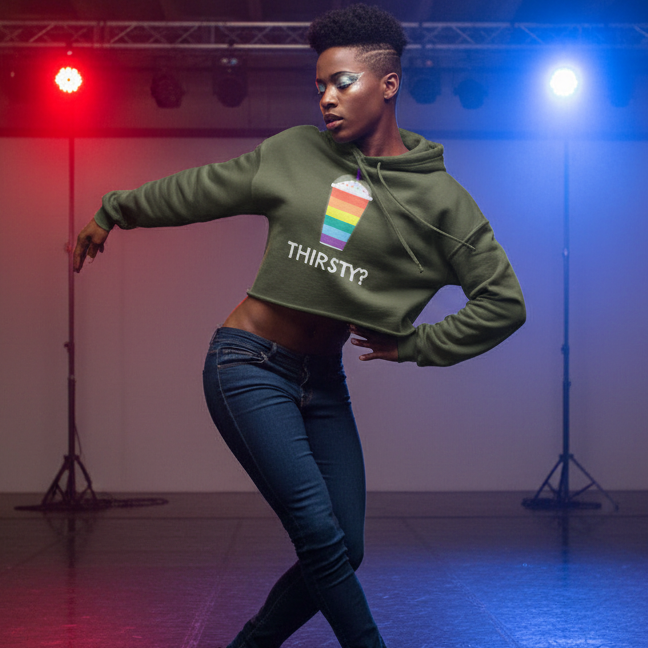 Thirsty? Crop Hoodie with a rainbow drink graphic, worn with dark jeans by a person dancing under red and blue studio lights