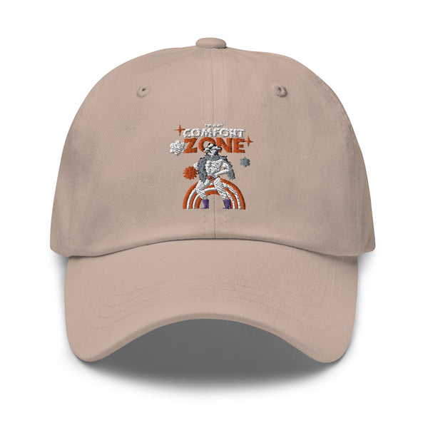 Front view of a beige cap embroidered with “COMFORT ZONE” and a seated figure