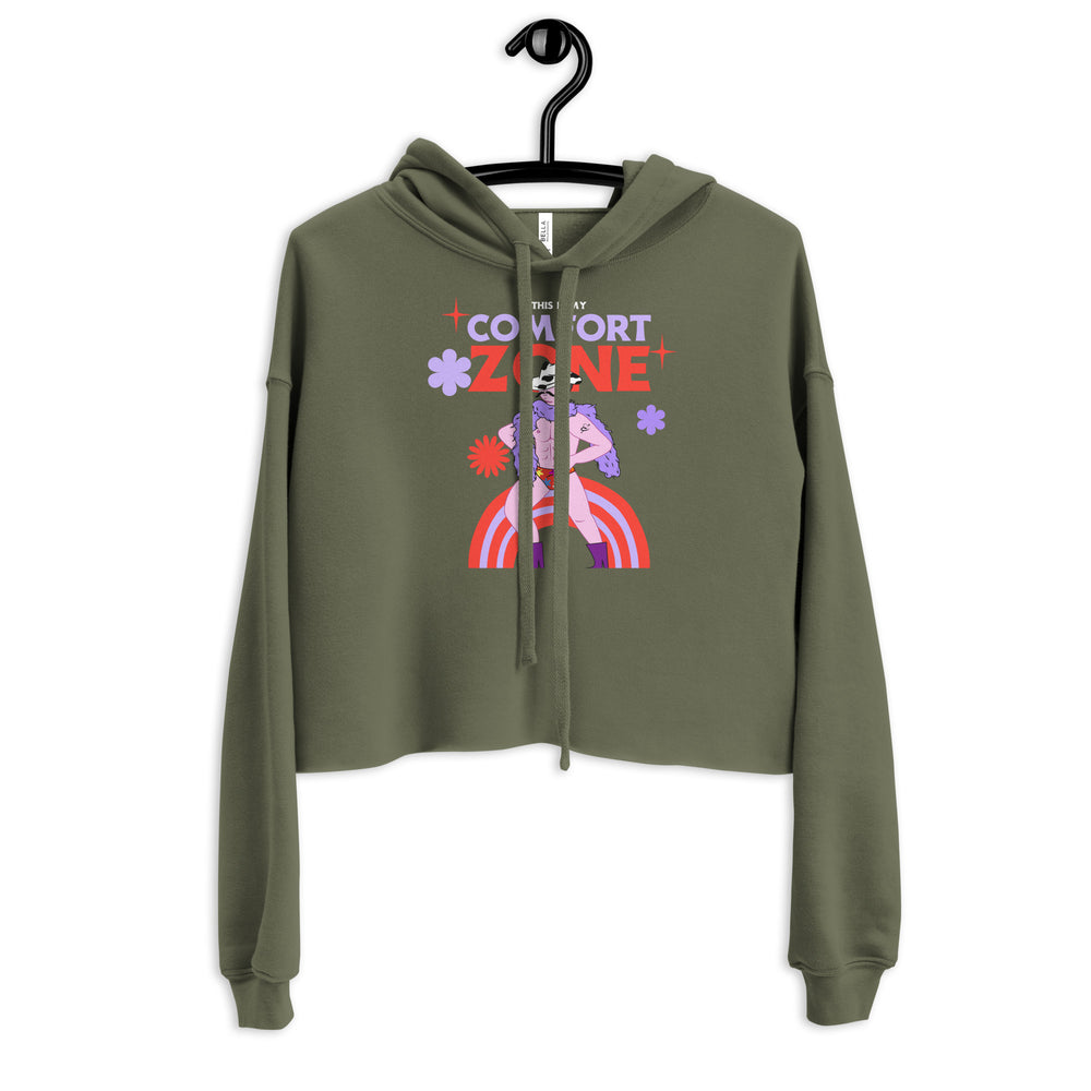 Front view of an olive cropped hoodie with a colorful figure, flowers, stars, and “THIS IS MY COMFORT ZONE” text