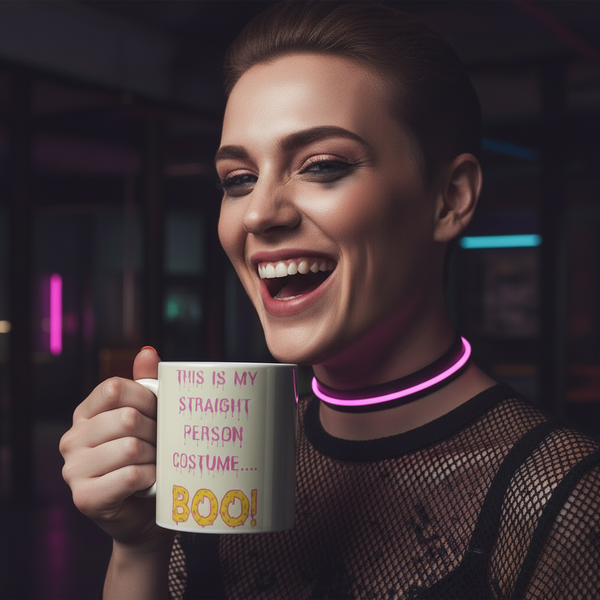 Smiling person holds a white mug reading “This Is My Straight Person Costume… Boo!”