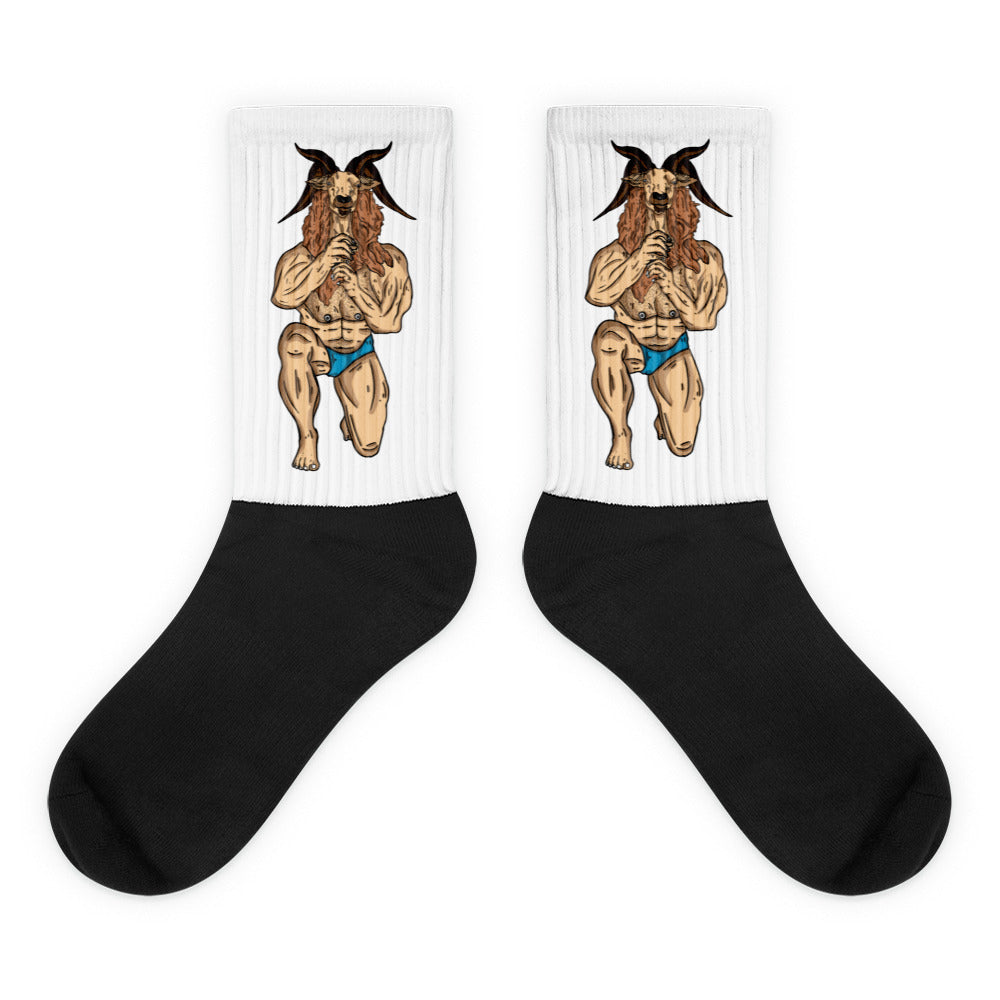 Pair of black-and-white crew socks with muscular goat figures in blue briefs