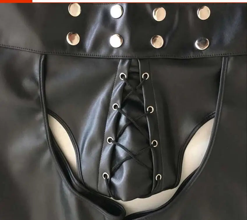 Close-up of black faux-leather shorts with side cutouts and a lace-up front