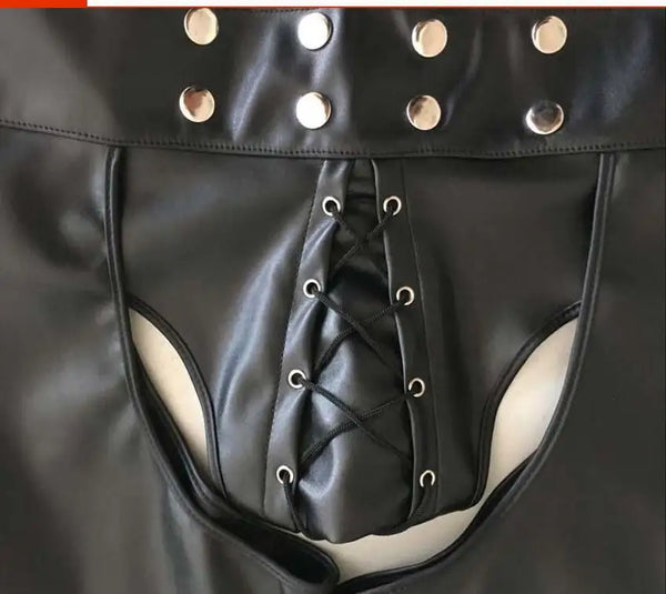 Close-up of black faux-leather shorts with side cutouts and a lace-up front