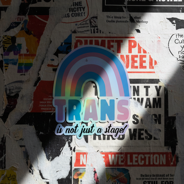 Holographic sticker with “The Trans Is Not Just A Stage!” in bold