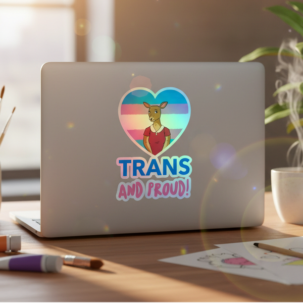 Heart-shaped holographic sticker with kangaroo and bold “TRANS AND PROUD!” on pastel blue, pink, white stripes