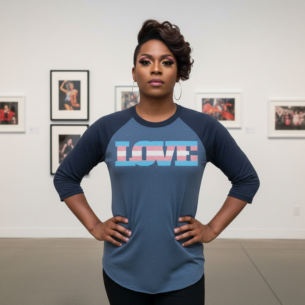 Person modeling a navy raglan shirt with “LOVE” in transgender pride colors