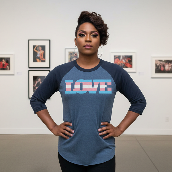 Person modeling a navy raglan shirt with “LOVE” in transgender pride colors