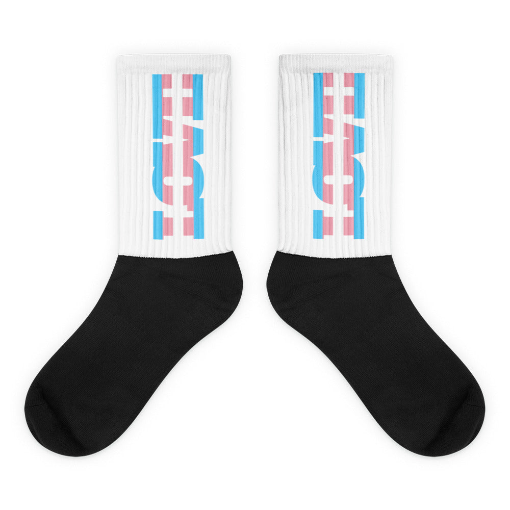 Pair of black-and-white socks with pink and blue geometric calf designs