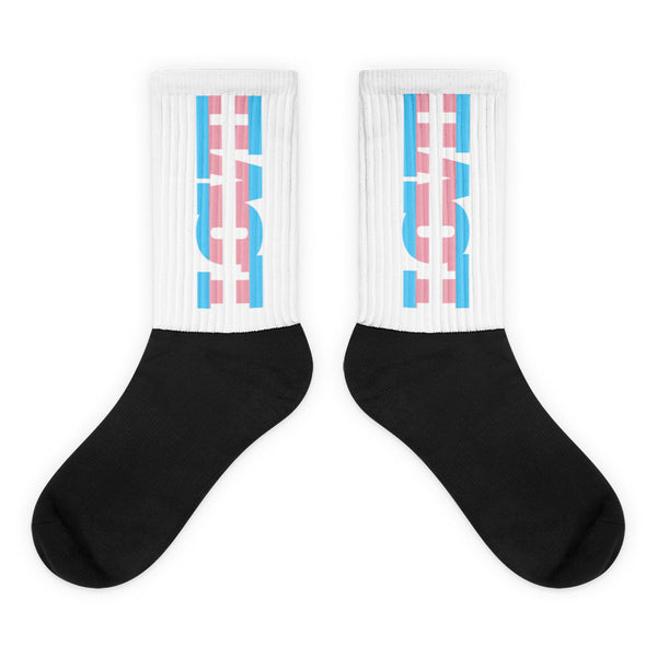 Pair of black-and-white socks with pink and blue geometric calf designs