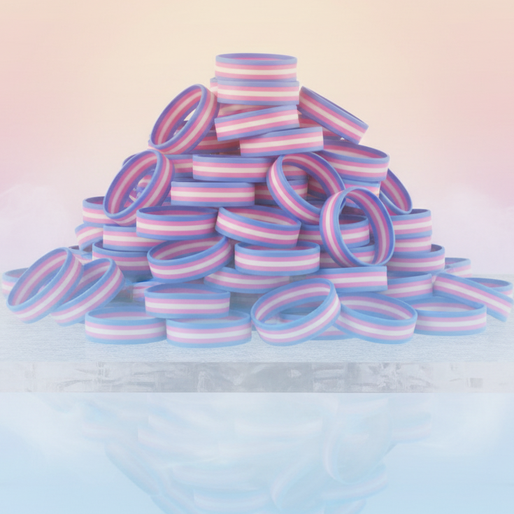 Pile of pastel blue, pink, and white striped silicone wristbands on a reflective surface