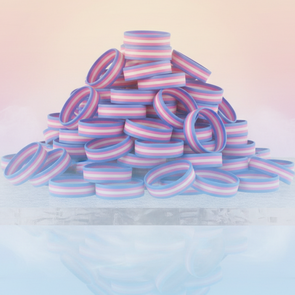 Pile of pastel blue, pink, and white striped silicone wristbands on a reflective surface