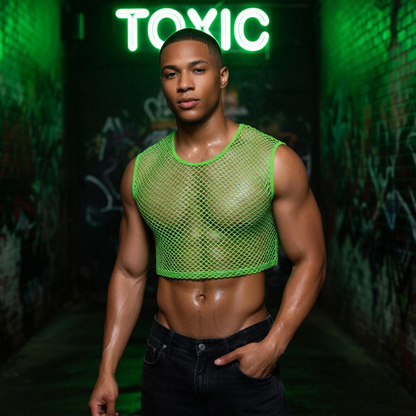 Model wearing a bright green fishnet crop top in a graffiti-lined alley