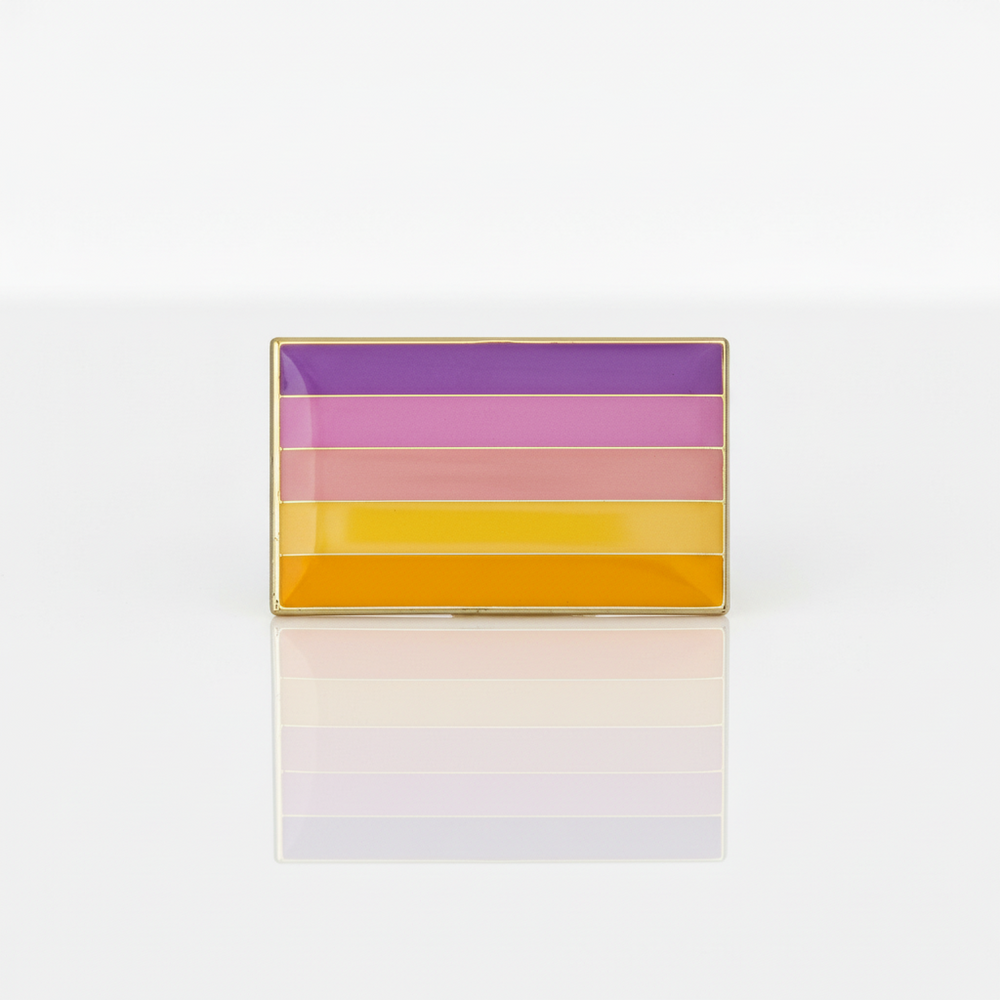 Rectangular gold-edged enamel pin with six purple, pink, yellow, and orange stripes, reflected below