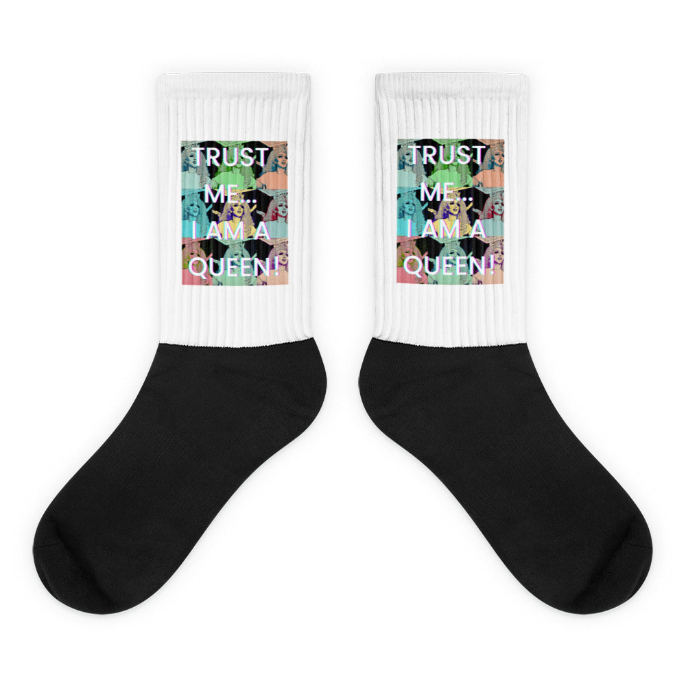 Pair of white-and-black crew socks with colorful queen portraits and “TRUST ME… I AM A QUEEN!”