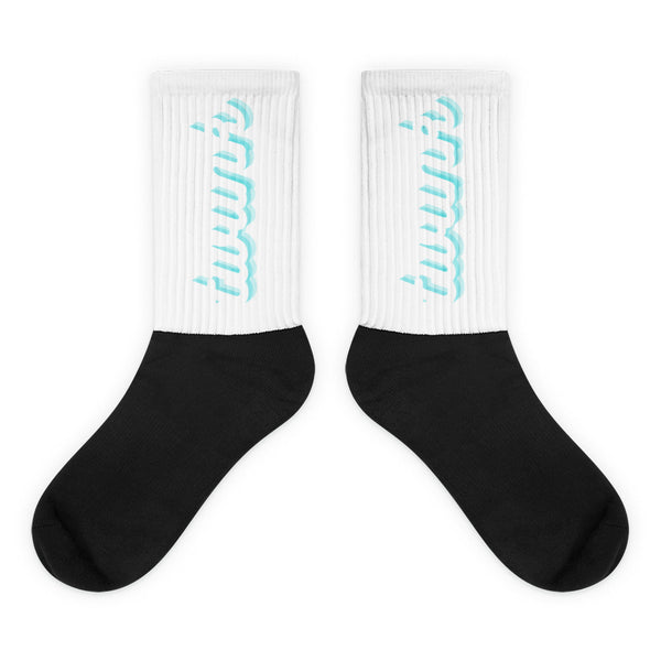 Pair of crew socks with white ribbed cuffs, turquoise lettering, and black feet