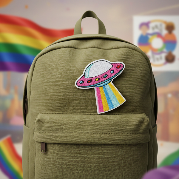 Olive-green backpack with UFO Pride rainbow-beam embroidered patch