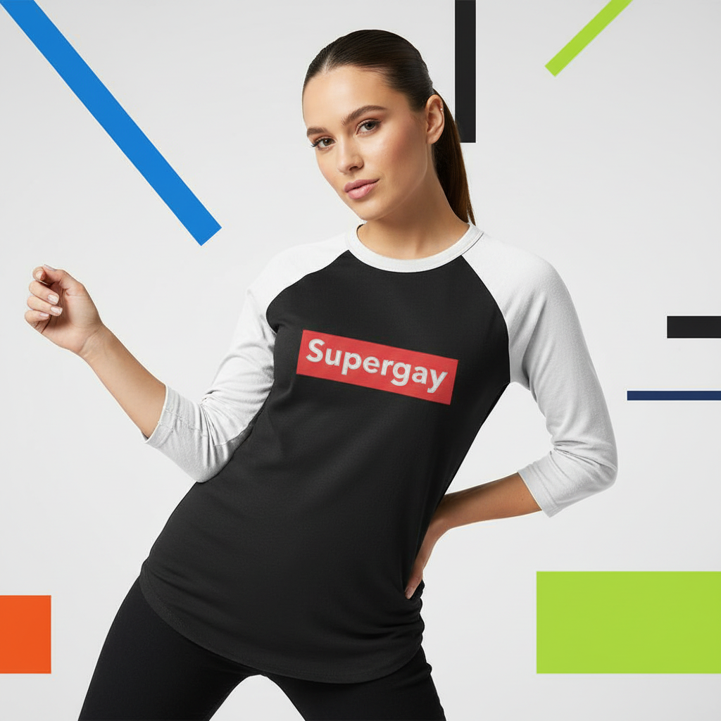 Young woman models the Supergay 3/4 Sleeve Raglan Shirt, featuring a bold red Supergay patch on a black-and-white design, embodying prideful, queer self-expression and empowerment with its soft, lightweight comfort.