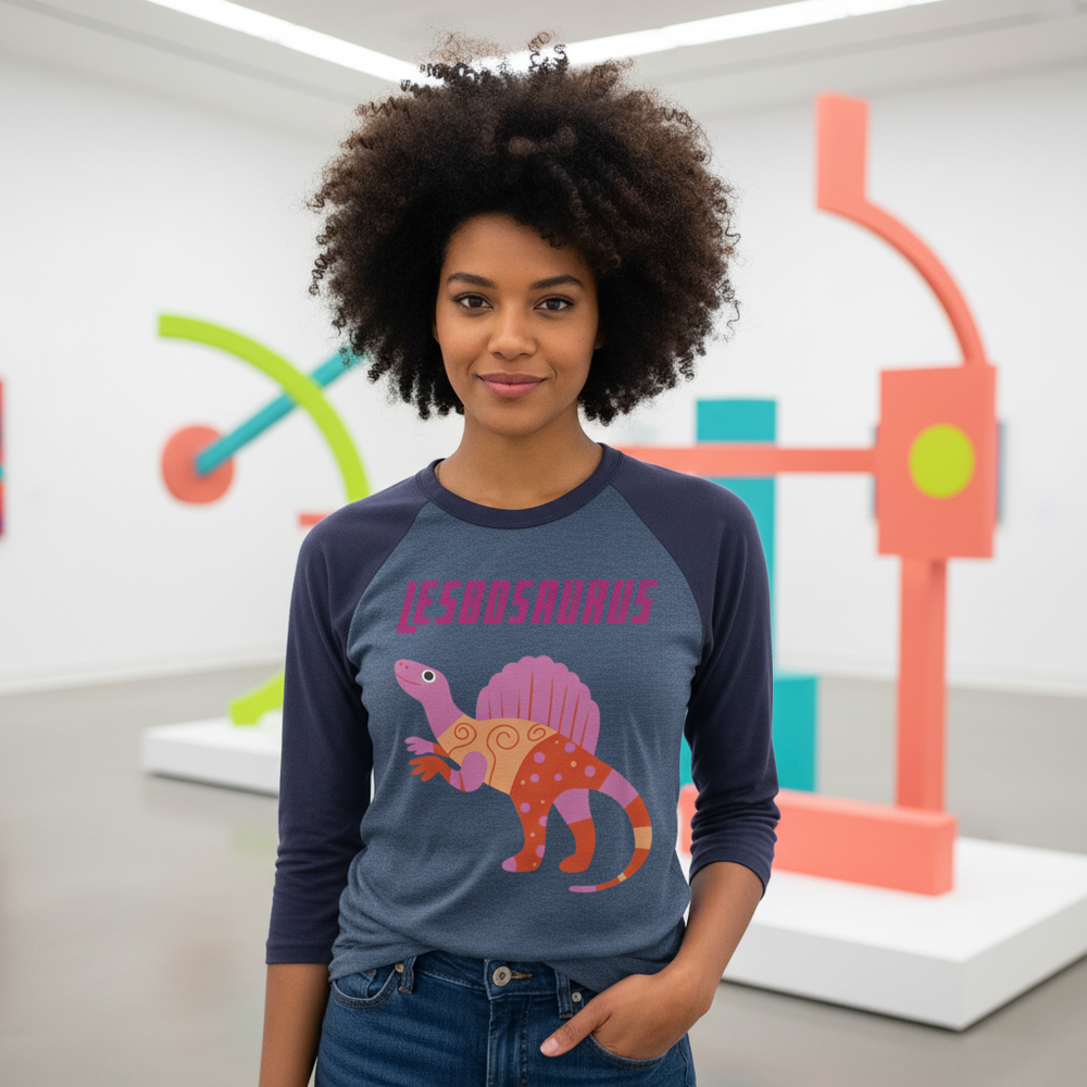 Lesbosaurus 3/4 Sleeve Raglan Shirt with bold “LESBOSAURUS” text and a proud cartoon dino, worn in a pastel art gallery.