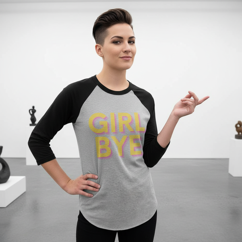 Gray and black Girl Bye 3/4 sleeve raglan shirt, "GIRL BYE" in pink and yellow, worn by short-haired person in art gallery.