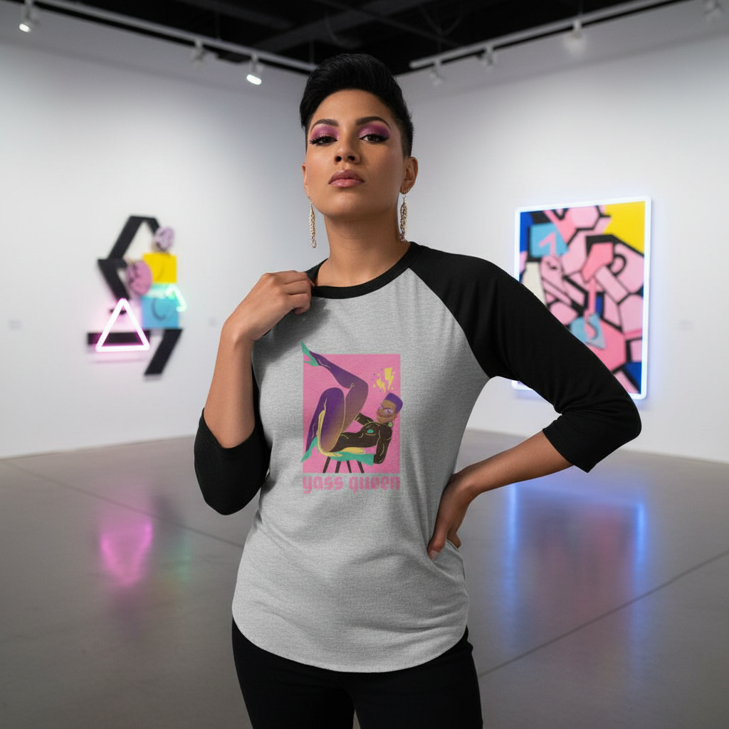 Model wears a gray raglan shirt with black three-quarter sleeves and “YASS QUEEN” graphic