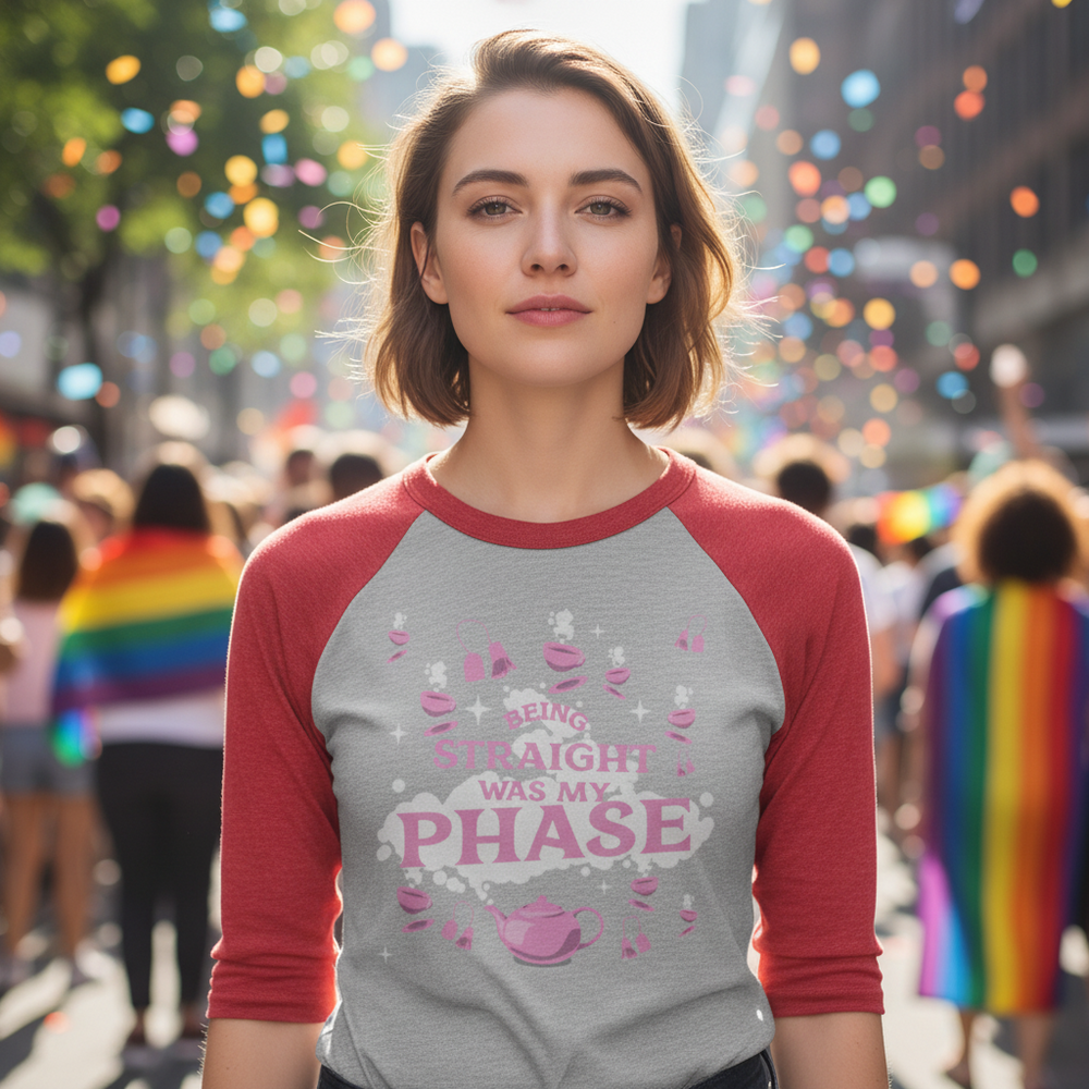 3/4 sleeve raglan shirt with red sleeves and "Being Straight Was My Phase" slogan, worn at a pride parade with rainbow flags.