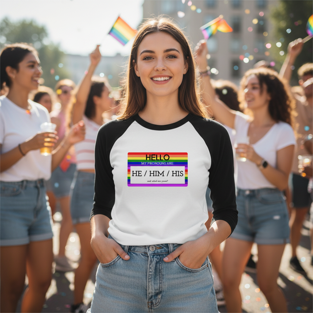 Hello My Pronouns Are He / Him / His" 3/4 sleeve raglan shirt on a happy queer person at Pride, with pride flags and confetti.