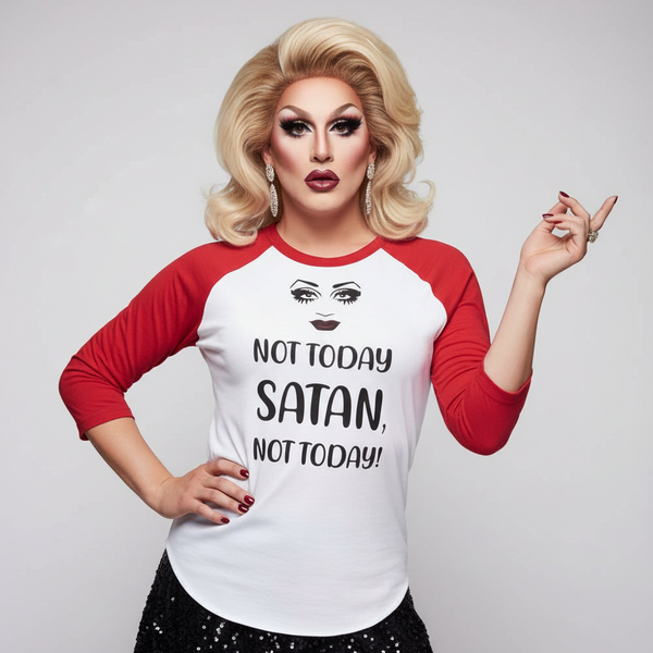 Drag performer wearing a red-and-white raglan shirt reading “Not Today Satan, Not Today!”