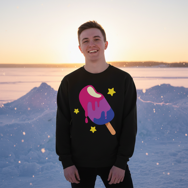 Model wearing a black sweatshirt with a colorful popsicle and star print in a snowy landscape