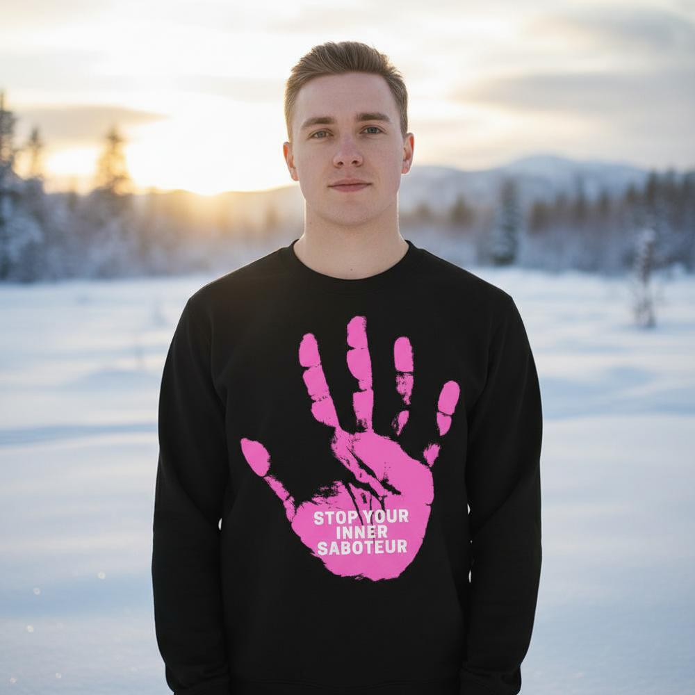 Model wearing a black sweatshirt with a pink hand graphic and “STOP YOUR INNER SABOTEUR” text